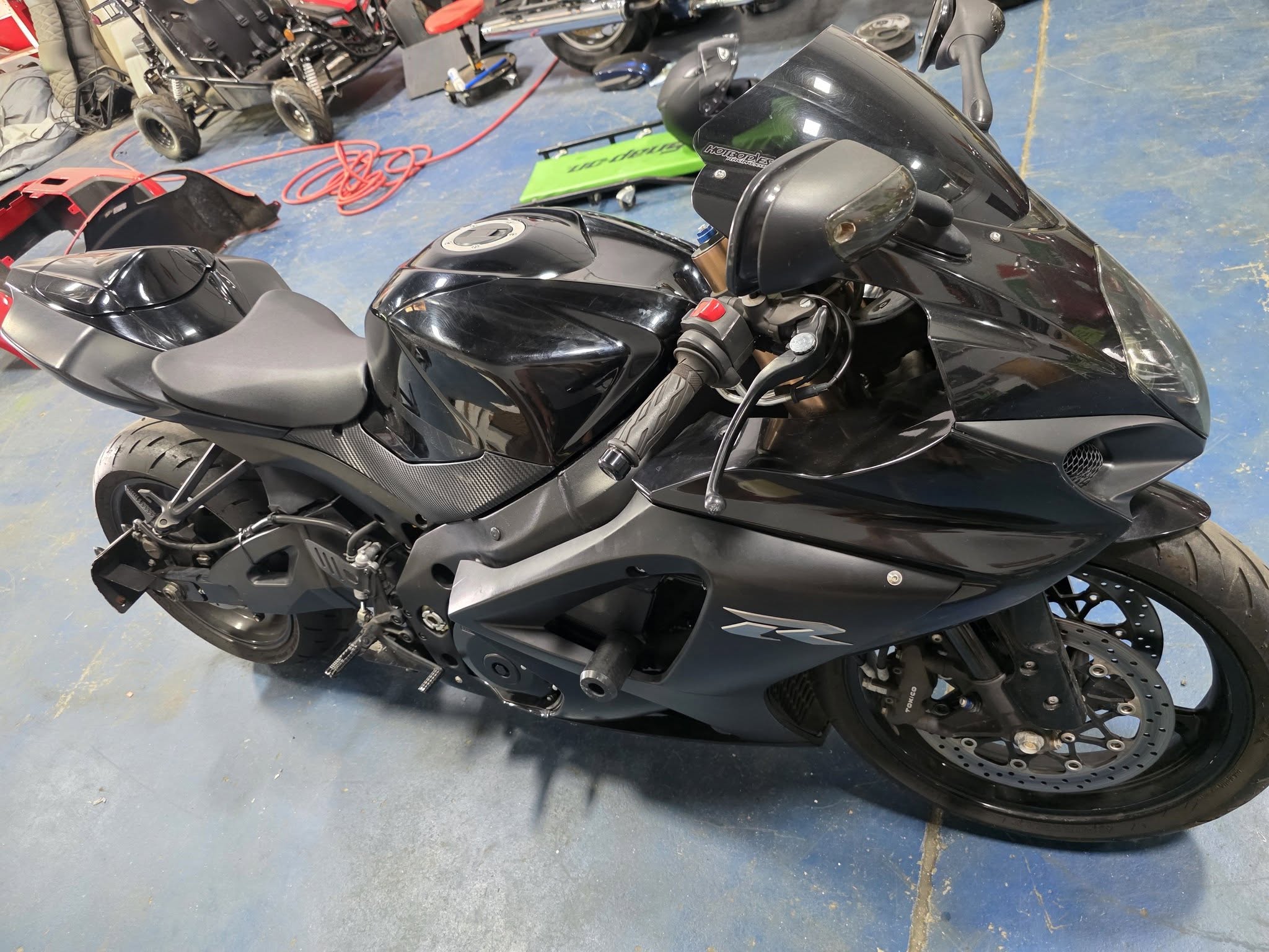 Custom Unlimited workshop floor in Grovetown GA — owner-operated motorcycle and audio build bay